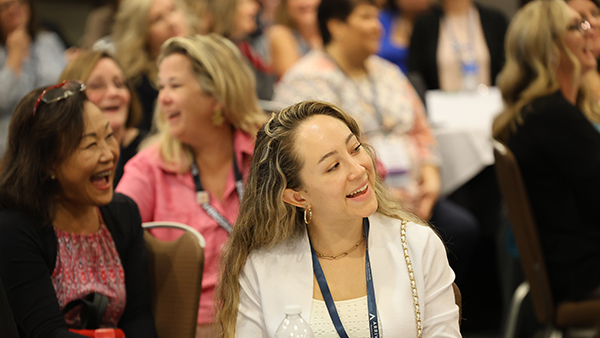 Members smiling during Conference session